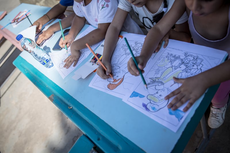 Displaced children colour during a Save the Children activity in northern Lebanon. Photograph: Sally Hayden