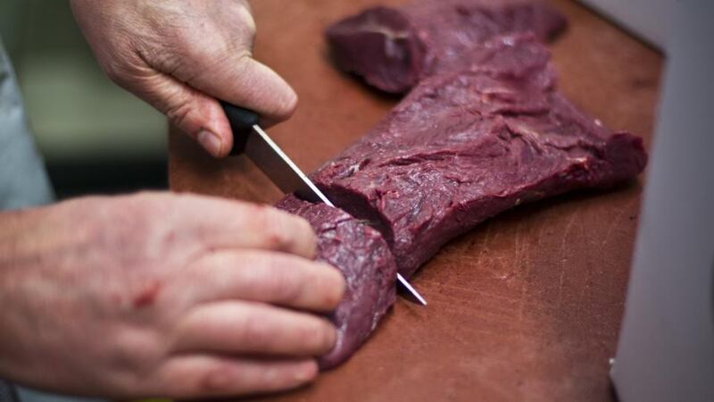 Peter Wisker cutting horsemeat. Photograph: Ilvy Njiokiktjien/AFP/Getty Images