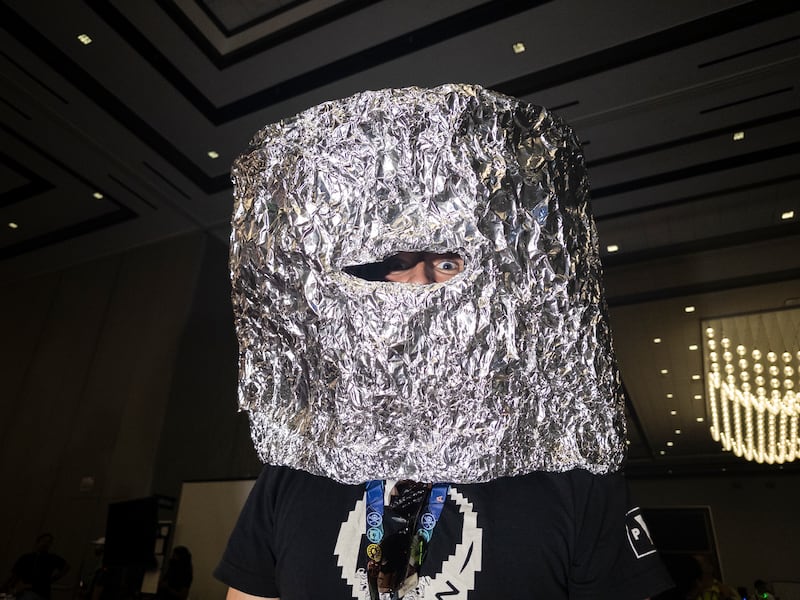 Mark Milhouse wearing a tinfoil hat at Defcon. Photograph: Mikayla Whitmore/The New York Times
                      