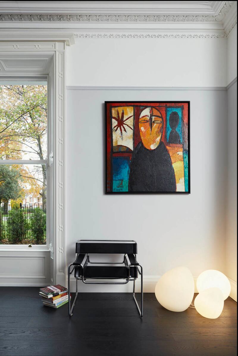 Carefully chosen artwork and additional light create an area of interest in a calm room. Photograph: Philip Lauterbach