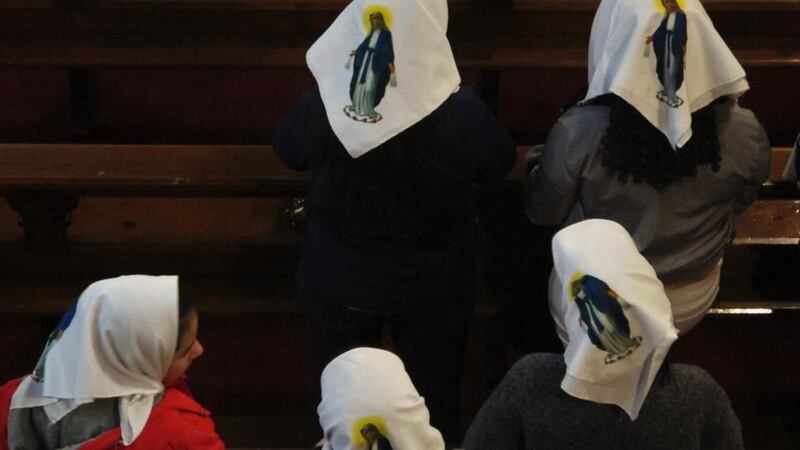 Copt women in prayer at Saints Maximus and Domadius Coptic Church. Photograph:  Shawn Pogatchnik