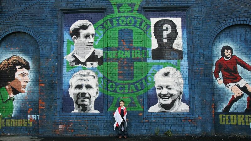 A young Northern Ireland fan stands infront of a tribute to past Northern Ireland legends in Belfast. Photograph: Christopher Lee/Getty Images