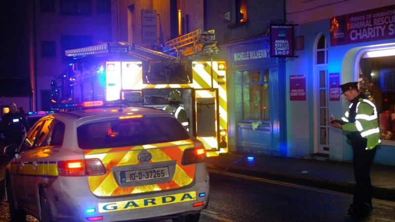 Garda and the Fire Brigade Service at the scene of the petrol bomb attack on Michelle Mulherin’s office in John St Ballina last night. Photograph:  Henry Wills