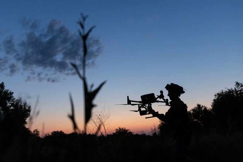 A Ukrainian soldier catches a drone used to correct Ukrainian artillery fire on Russian positions in the Zaporizhzhia region of southern Ukraine. Photograph: David Guttenfelder/The New York Times
                      