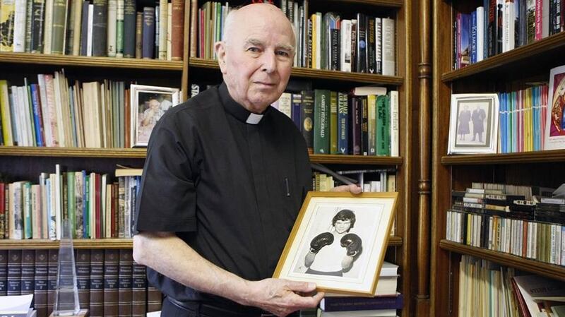 Bishop Daly with a photograph of Jackie Duddy in his office. Photograph: Courtesy of Derry Journal