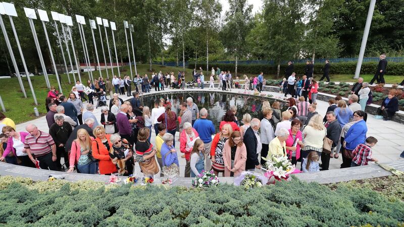 People visiting the Omagh memorial garden after attending the ceremony for victims of the car bomb on Market Street on the 15th August 1998, the worst single atrocity of the Northern Ireland conflict which killed 29 people, including a woman pregnant with twins.  Photograph: Niall Carson/PA