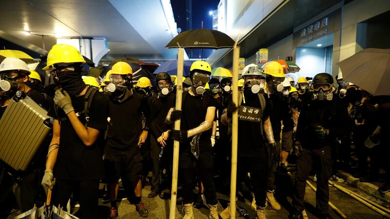 Protesters prepare to confront riot police in Hong Kong on Sunday. Photograph: Vincent Yu/AP