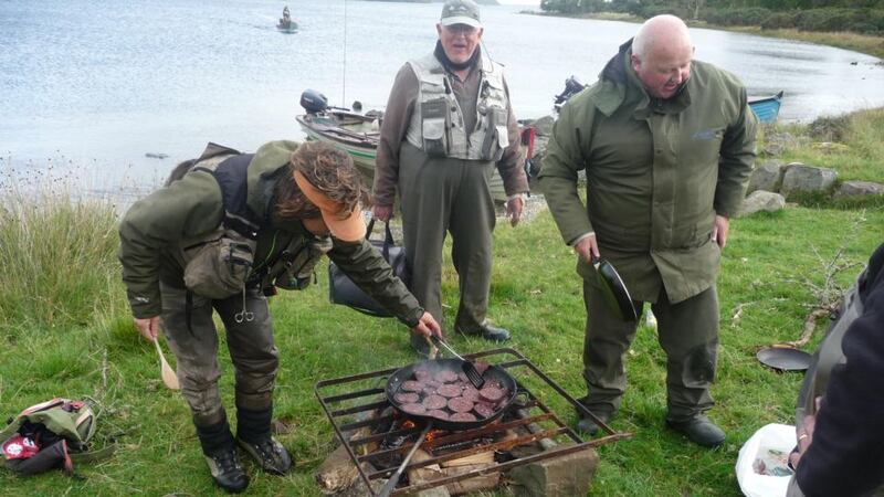 Barbecue gets underway on Inishnawee Island with Maam black pudding on the fishing rod frying pan during the Cornamona and Killarney competition.