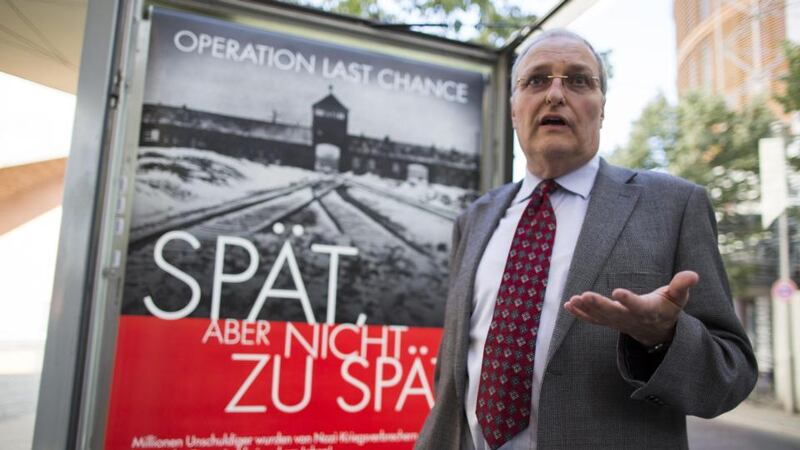 Efraim Zuroff, the Simon Wiesenthal Centre’s chief Nazi hunter, in front of a placard reading “Operation last chance - late but not too late”, in Berlin. Photograph: Gero Breloer/AP