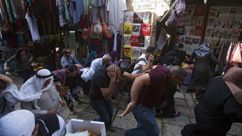 Palestinians run away to escape the violence. Photograph: Atef Safadi/EPA