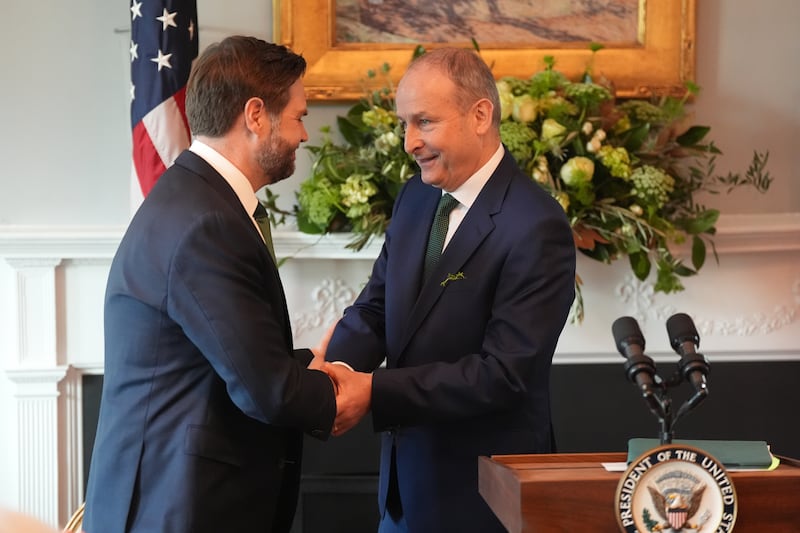 Mr Vance shaking hands with the Taoiseach who, prior to meeting, thanked the vice-president for his 'warm welcome and hospitality' and joked that he would need to 'adjust very rapidly' his 'conservative' dress sense after seeing the shamrock socks. Photograph: Niall Carson/PA Wire