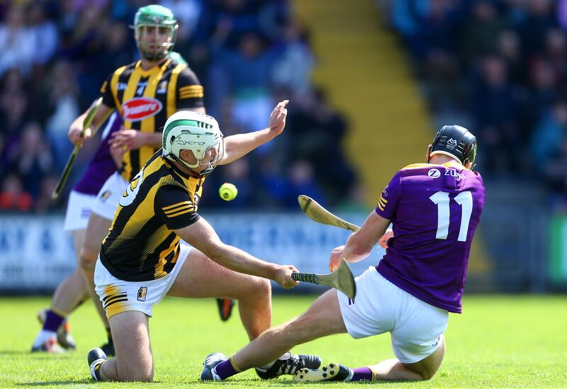 Wexford’s Liam Óg McGovern finishes one-handed to the net past Kilkenny’s Padraig Walsh during the game at Wexford Park. Photograph: Ken Sutton/Inpho