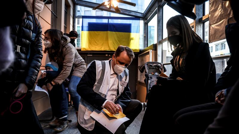 Ukrainians are registered by health workers while waiting to be vaccinated against  coronavirus  at the Ukrainian embassy in Berlin, as part of a campaign by the city’s health authorities to vaccinate people fleeing the war in their country. Photograph: Filip Singer/EPA