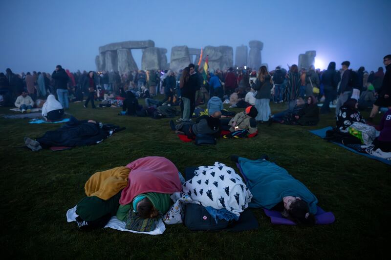 People wait for the sun to rise at Stonehenge in Wiltshire, England for  the Summer Solstice. Photograph: Finnbarr Webster/Getty