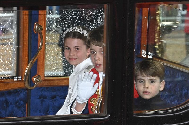 Princess Charlotte, Prince George and Prince Louis travel back to Buckingham Palace from Westminster following the coronation of King Charles III and Queen Camilla. Photograph: Justin Tallis/WPA Pool/Getty Images