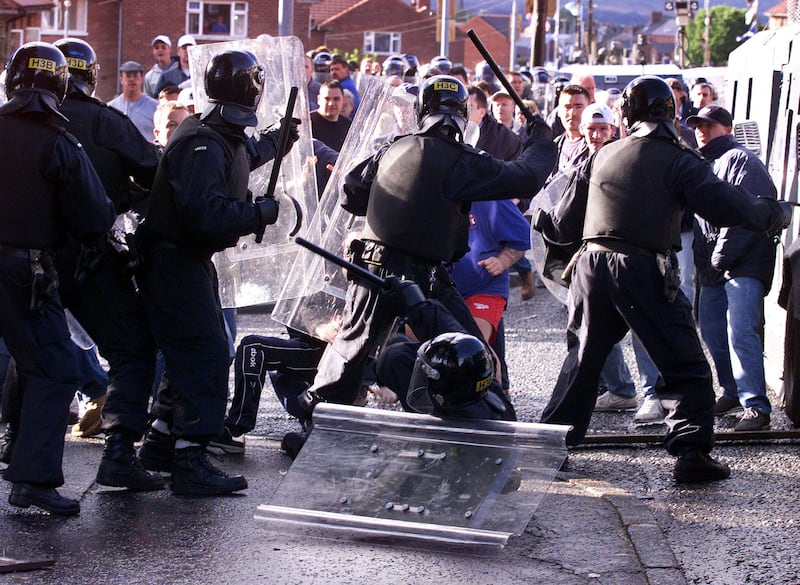 Protestants clash with police in riot gear in north Belfast as they tried to stop Catholic schoolchildren from attending the Holy Cross Primary School in the Ardoyne district of Belfast on the first day of the new school term in September 2001. Photograph: Paul Faith/PA Wire