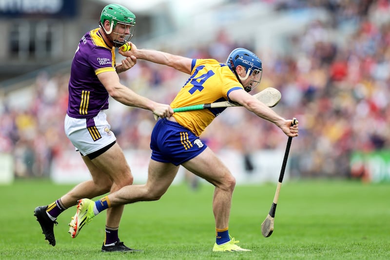 Clare's Shane O’Donnell and Matthew O'Hanlon of Wexford, 2024 All-Ireland Senior Hurling Championship quarter-final, FBD Semple Stadium, Thurles, Tipperary. Photograph: Laszlo Geczo/Inpho