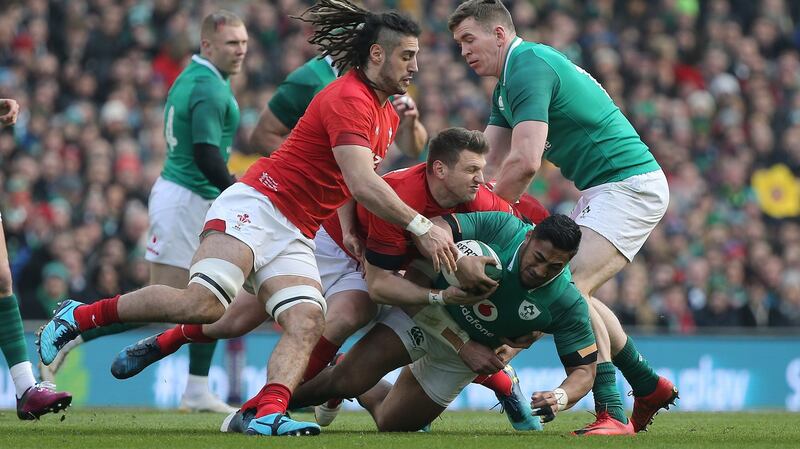 Bundee Aki is tackled by Wales players Josh Navidi and Dan Biggar last year at the Aviva Stadium. Photograph: Tom Honan