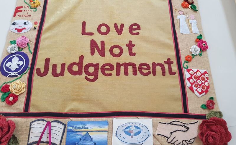 ‘Love not judgement’: A banner commissioned by campaigning priest Fr Tony Coote hangs in the Church of St Thérèse, Mount Merrion, Dublin where he worked before his death in 2019