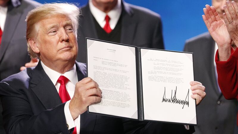 US president Donald Trump displays a signed executive order, expanding rural broadband access to towers on federal lands. Trump said lower taxes and deregulation would rev up the rural economy. Photograph: Luke Sharrett/Bloomberg via Getty Images