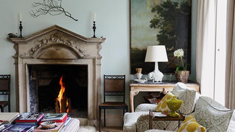 The striking feature of the sitting room is the beautiful fireplace. On either side of the chimneypiece hang two Dutch panels and over the fireplace, a bronze branch by the sculptor Dan Chadwick. Photograph: by Christopher Simon Sykes.