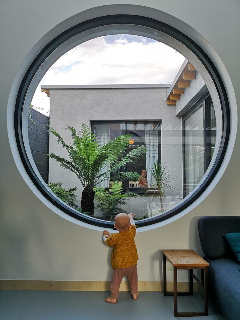 One of the two internal courtyards is viewed through a large round window