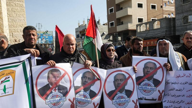 Palestinian demonstrators chant slogans while holding portraits of US president Donald Trump and Israeli prime minister Binyamin Netanyahu,in Rafah in the southern Gaza strip on Tuesday.  Photograph:  Said Khatib/AFP via Getty Images