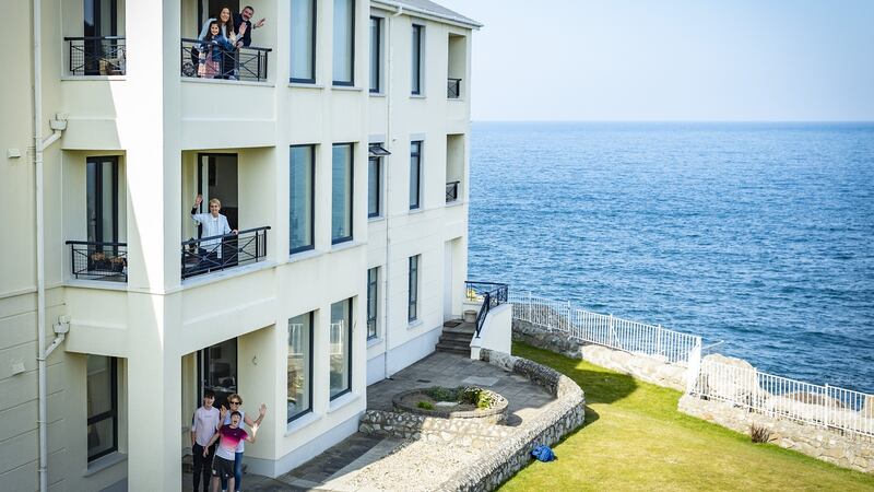 Three generations of the Charlton family on their balconies: Gerry Charlton on top, Maeve in the middle and Denise Charlton and family at ground level.