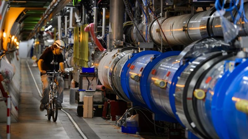 A worker rides by on his bicycle in Cern’s Large Hadron Collider tunnel during maintenance works, near Geneva. Photograph: Fabrice Coffrini/AFP/Getty Image