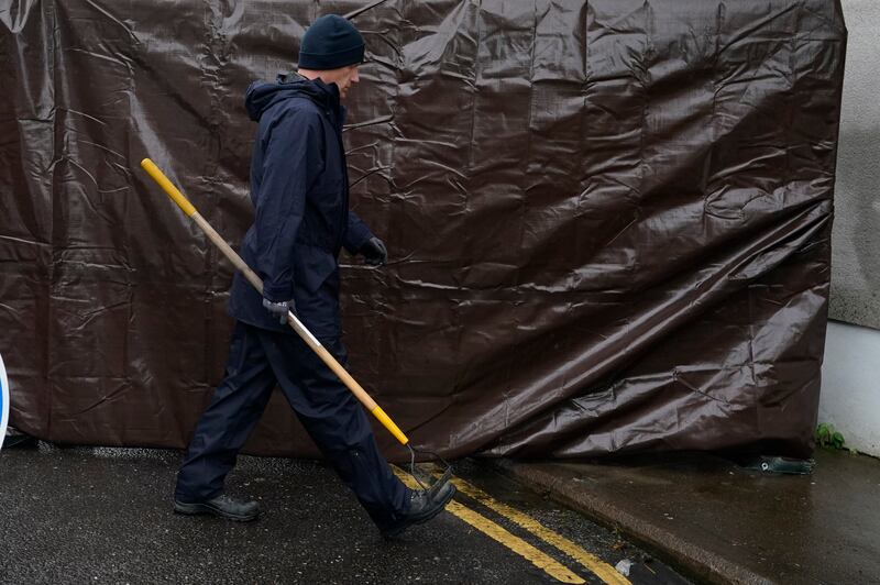 A specialist Garda search officer enters a property in Youghal, being searched in the case of missing Co Cork woman Tina Satchwell. Photograph: Niall Carson/PA Wire