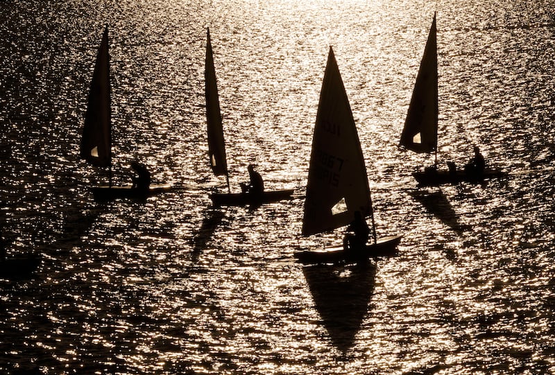 Participants in the DMYC Frostbite Series racing within Dun Laoghaire Harbour as low winter sun illuminates the course. Photograph: Alan Betson / The Irish Times