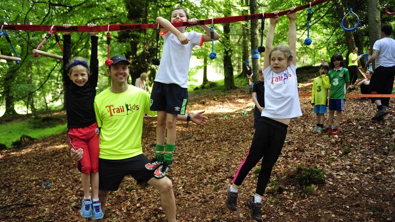 Kevin O’Brien (centre)  with Ciara Fiery, Devon Brady and Charlotte Ball, members of his Trail Kids group in Cruagh Woods in the Dublin mountains. Photograph: Aidan Crawley