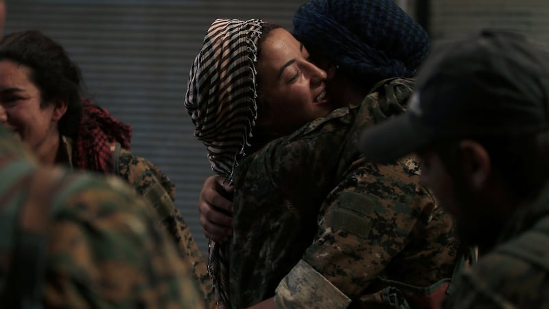 Syria Democratic Forces (SDF) female fighters embrace each other in  Manbij. Photograph: Rodi Said/Reuters