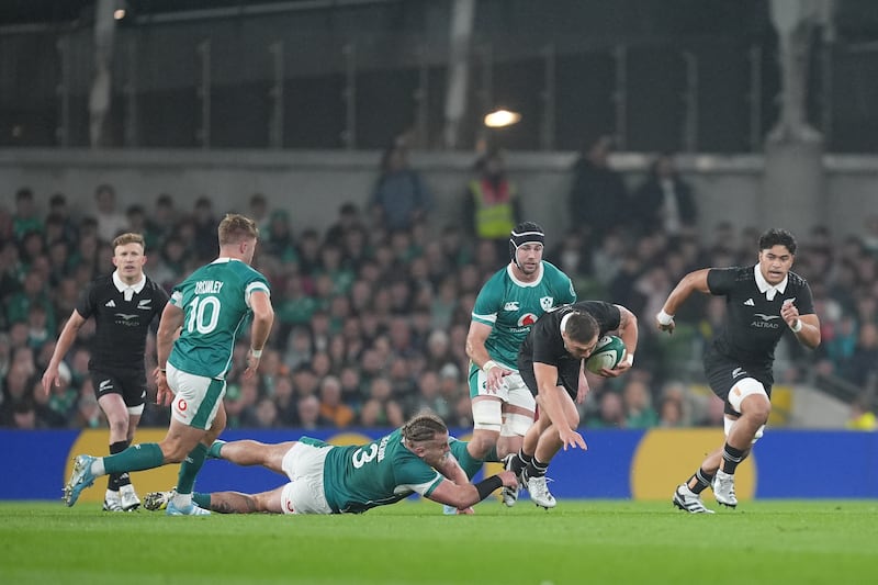 New Zealand's Cortez Ratima (centre right) is tackled by Ireland's Finlay Bealham. Photograph: Niall Carson/PA