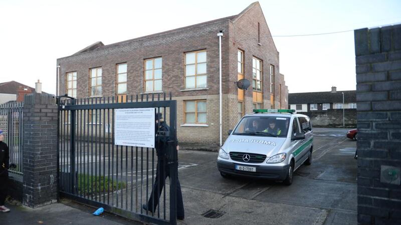 An ambulance takes away the remains found at the apartment block at Wellmount Road, Finglas, Dublin, on Saturday. Photograph: Dara Mac Dónaill/The Irish Times