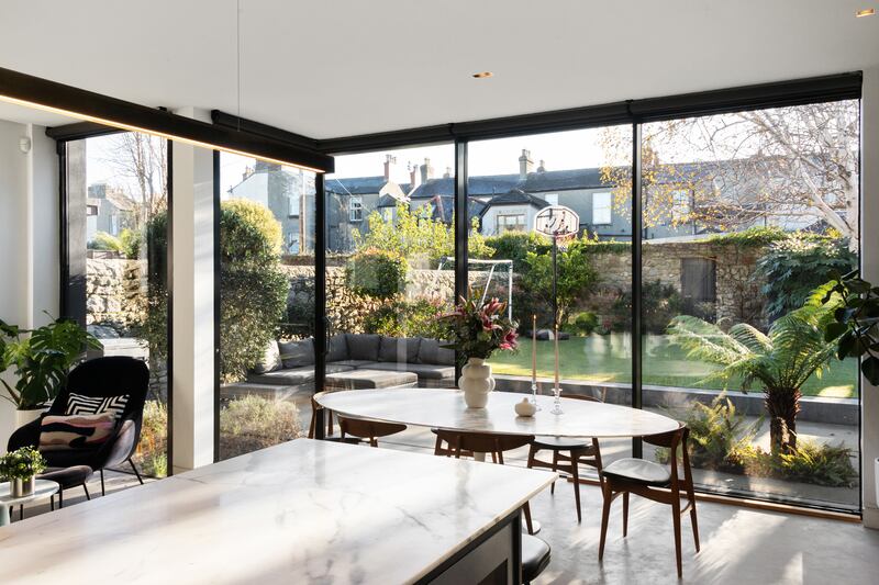 A bright extension to the rear houses a living, dining and kitchen space