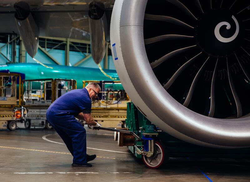 Making an adjustment with a lift holding the engine. Photograph: Lindsey Wasson/The New York Times