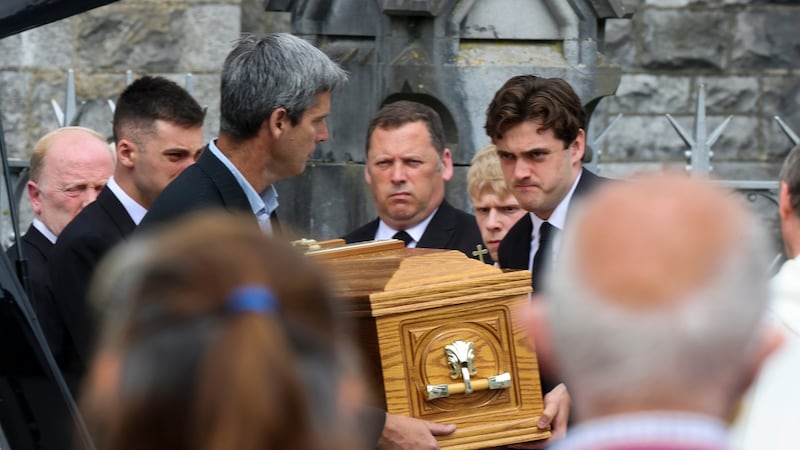 The coffin of May Cowen is carried out of church by her son Barry Cowen TD, and other family members. Photograph: Tom Honan/The Irish Times