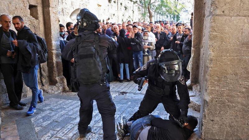 Israeli security forces immobilise a Palestinian man at an entrance to the al-Aqsa mosque compound as others are prevented from entering. Photograph: Hazem Bader/AFP via Getty Images