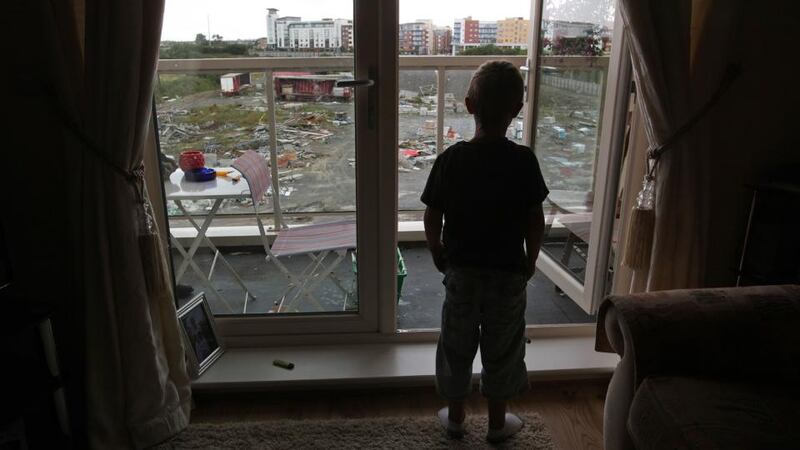 A child at his apartment window in the unfinished estate of Belmayne, Dublin, in 2011. File photograph:  Fran Veale