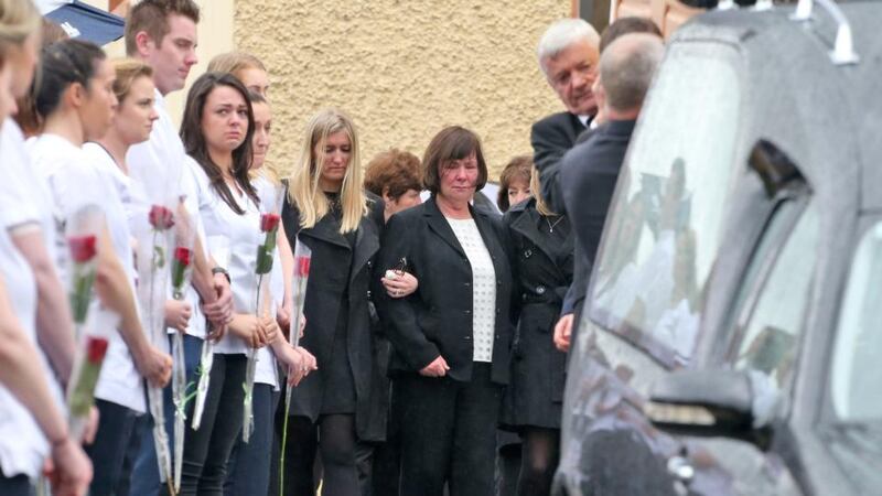 Karen Buckley’s mother Marian looks on as Karen’s father John, and two of her brothers carry her remains. Photograph: Collins