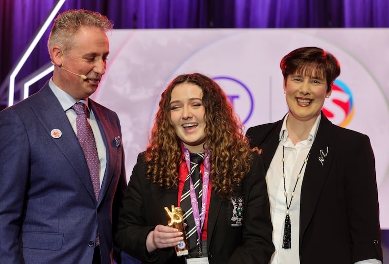 Philippa McIntosh (centre) from Bandon Grammar School at the BT Young Scientist & Technology Exhibition with Minister for Education Norma Foley. Photograph: Alan Betson

