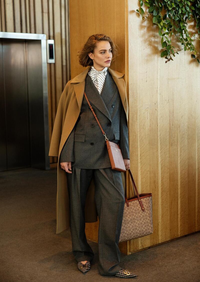 Camel coat €605 Weekend by MaxMara, grey wool double breasted blazer €449, grey pleated trousers €229 both Hugo Boss, striped bow blouse €240 See by Chloe, logo tote €350 and cross body bag €150 both Coach, tweed check sling backs €895 Balenciaga, all from Brown Thomas