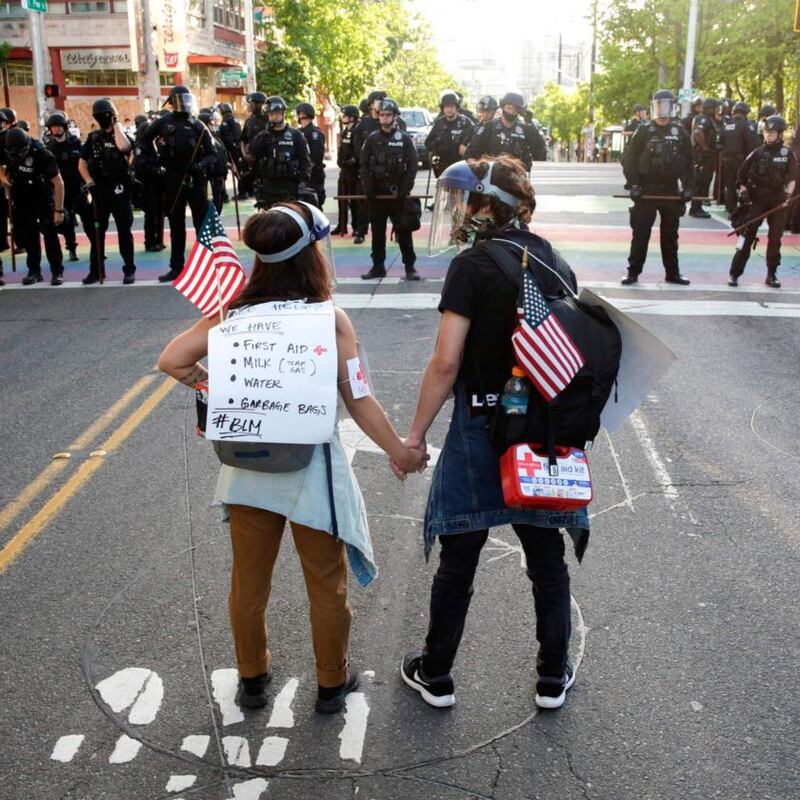 A couple stand together in Seattle on Monday. Photograph: Jason Redmond/AFP/Getty