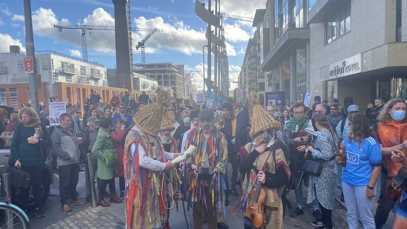 Masked mummers in straw pieces prepare to lead Saturday’s protest from Smithfield Square to O’Connell Bridge. Photograph: Sorcha Pollak