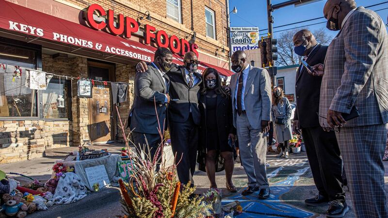 Members of George Floyd’s family, with their lawyer  Ben Crump (right), visit a memorial at the site on March 12th where George Floyd died while being arrested. Photograph: Kerem Yucel/AFP via Getty Images