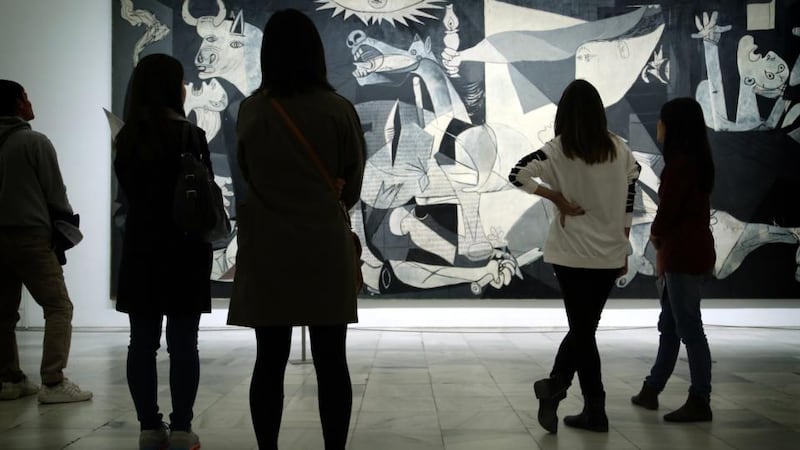 Museum visitors take in Picasso’s Guernica.