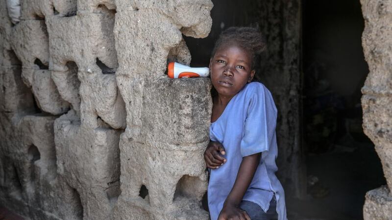 A girl poses in a neighbourhood filled with displaced people in Maiduguri, northeast Nigeria. The population of the city has swelled to double since the war began. Photograph: Sally Hayden