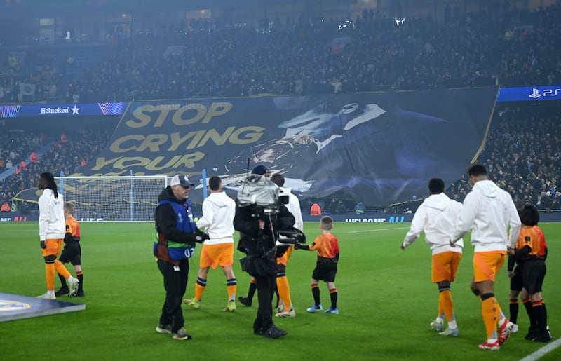 Fans of Manchester City display a tifo which reads 'Stop crying your heart out' which includes a picture of Rodri. Photograph: Michael Regan/Getty