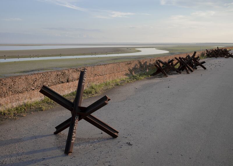 Anti-tank obstacles along the banks of the drying Kakhovka reservoir on the Dnieper river in the Dnipropetrovsk region of Ukraine. Photograph: Emile Ducke/The New York Times